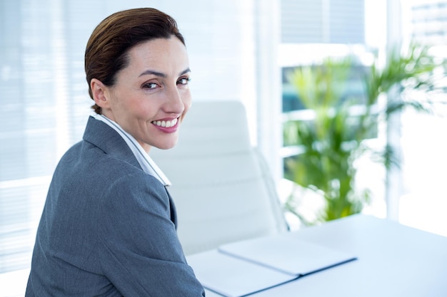 Female professional, business attire, approachable smile, office background